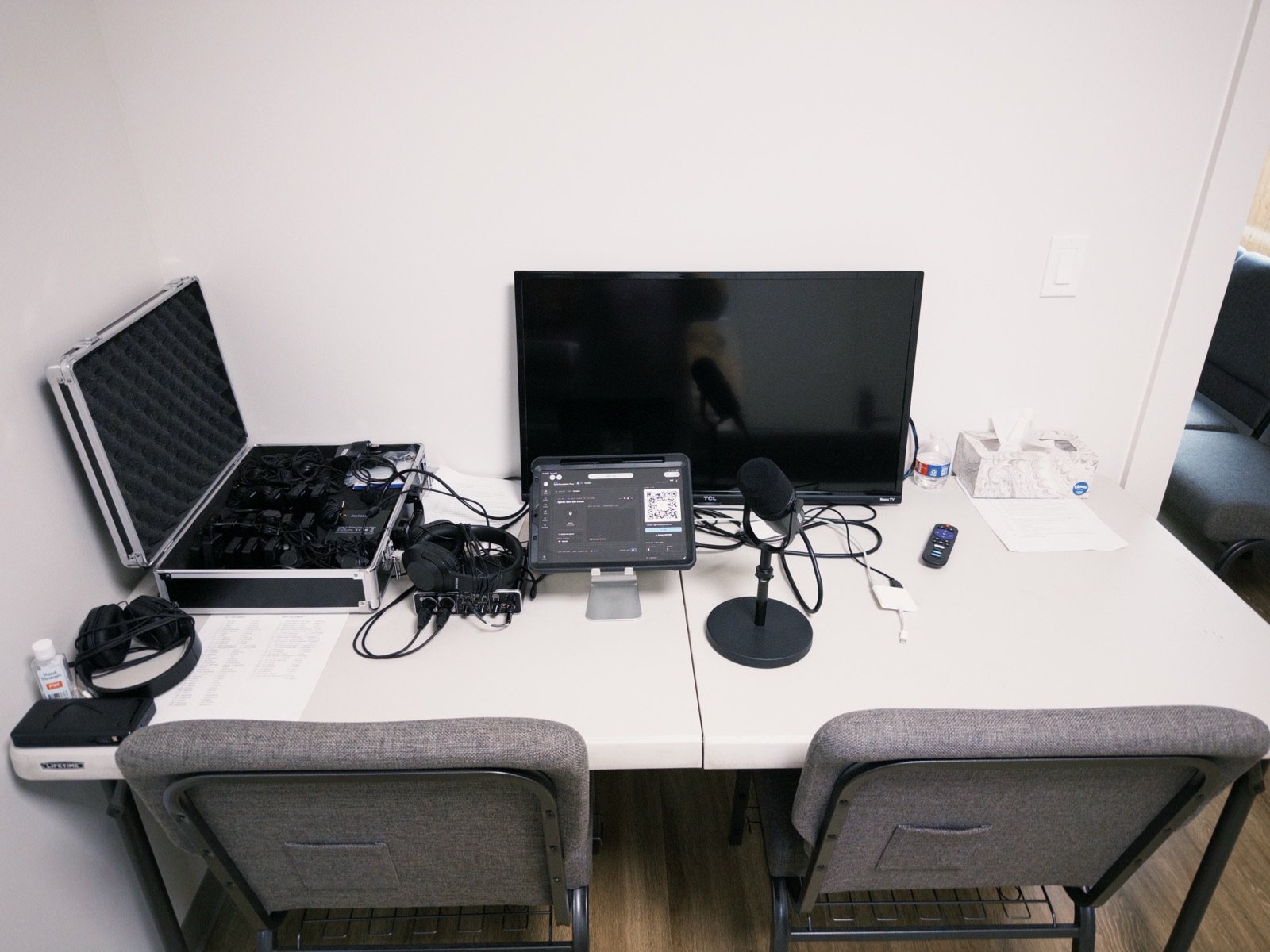 The translation booth at Solid Foundation Texas: headset receivers in a case beside an iPad running VoxLive
